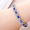 Oval Cut Sapphire Tennis Bracelet in Sterling Silver