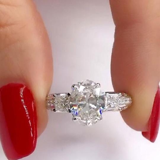 Oval Cut Engagement Ring with Two Princess Sidestones